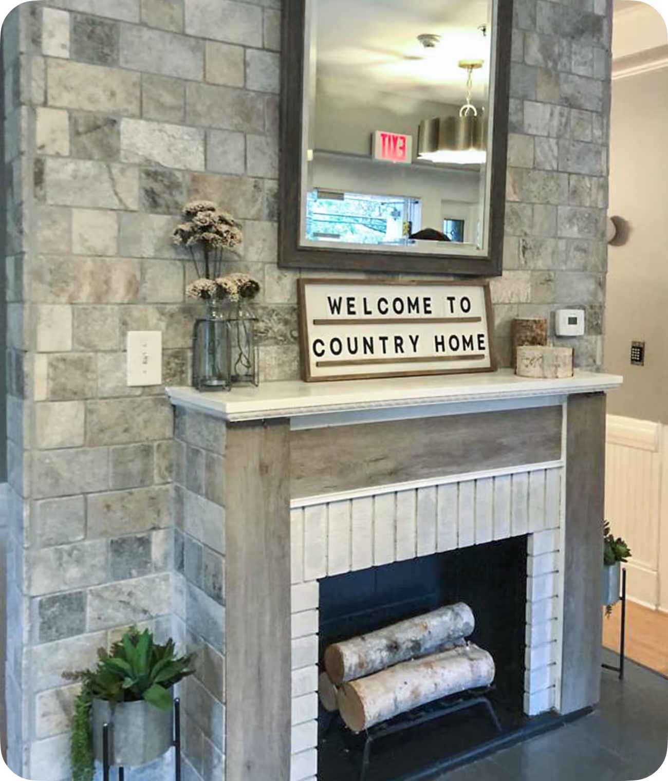 The stone fireplace with its Welcome to Country Home sign